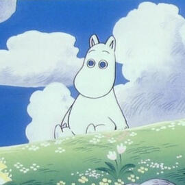 Moomin, a white troll that looks like a hippo, is outside on a bright day. He sits, in gradient lime green grass and looks blankly at the camera. There are also white fluffy clouds in a dark blue sky (matching the color of his eyes) and white colored tiny